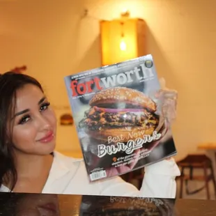 a woman holding a magazine