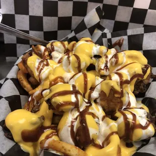 a plate of fries with cheese sauce