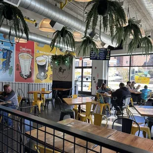 people sitting at tables in a restaurant