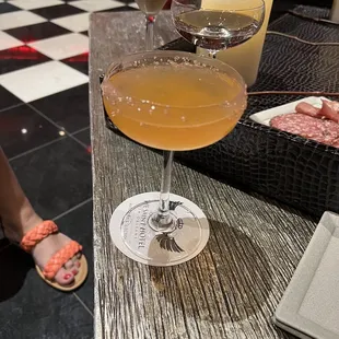 two glasses of wine and a plate of meat