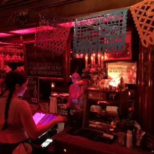 a woman working at a bar