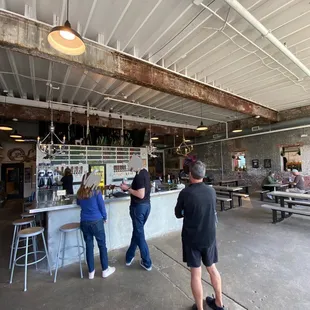 a group of people standing around a bar