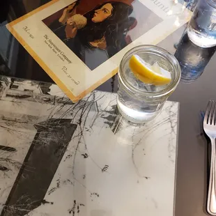 a glass of water and a menu