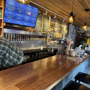 a bar with a man sitting at the bar