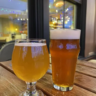 two glasses of beer on a table