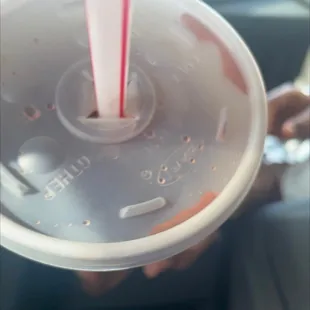a plastic cup with a straw sticking out of it
