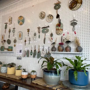 a wall of pots and plants