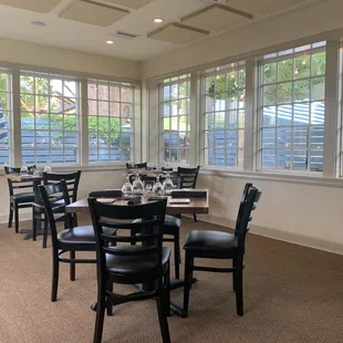 a dining room with tables and chairs