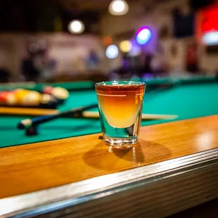 a shot of alcohol on a pool table
