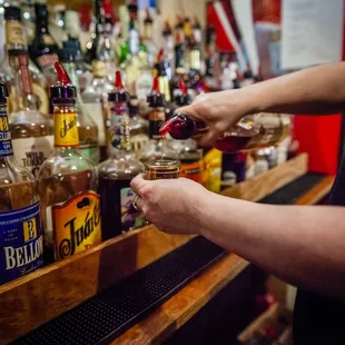 a bartender pouring a drink