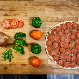 a pizza with pepperoni and tomatoes