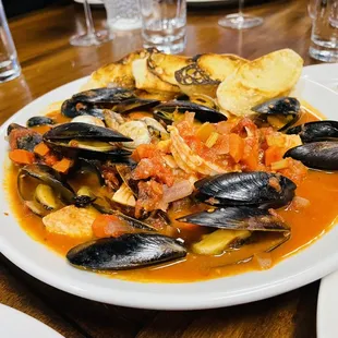 a plate of mussels and potatoes
