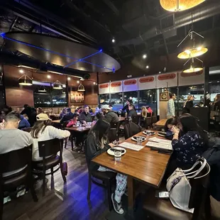 people sitting at tables in a restaurant