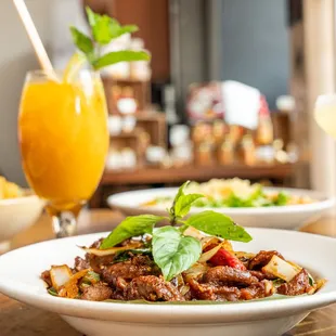 a plate of food and a glass of orange juice