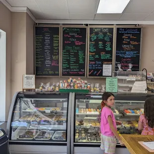 a woman and a young girl standing in front of the counter