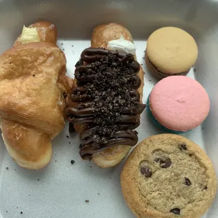 Coconut filled croissant, Oreo specialty croissant, macarons and icing filled cookie sandwich