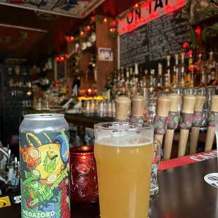 a glass of beer and a can of beer