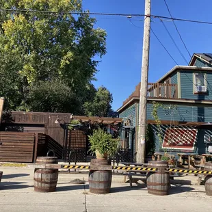 a row of barrels in front of a house