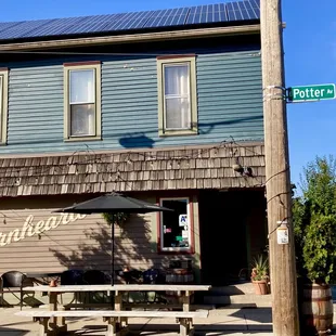 a blue building with a green roof