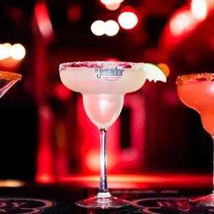 three cocktails on a bar