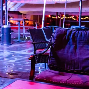 a chair and umbrella on a rainy day