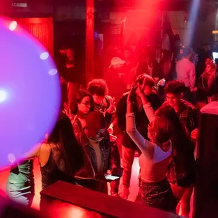 a crowd of people dancing at a party