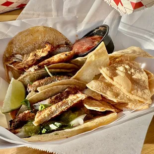 a basket of tacos and chips