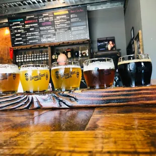 a row of beers on a bar