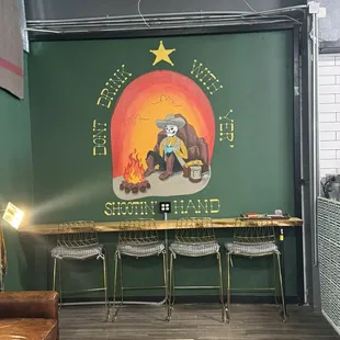 a green wall with a painting of a bear on it