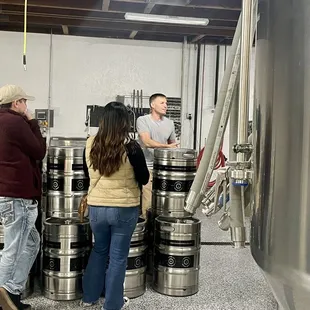 a group of people standing in a brewery