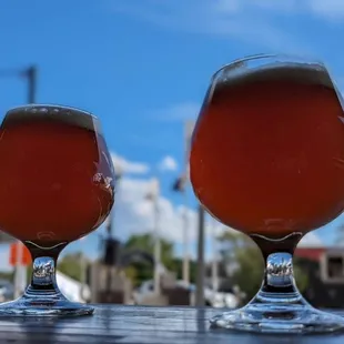 two glasses of beer on a table