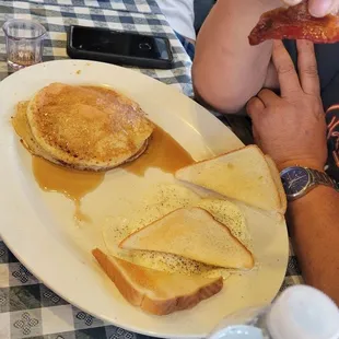 a person sitting at a table with a plate of food
