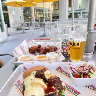 a tray of food and a glass of beer
