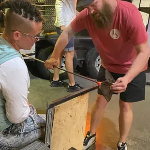 He uses the wet newspaper to help smooth out the glass after it's been pulled. WET NEWSPAPER!!