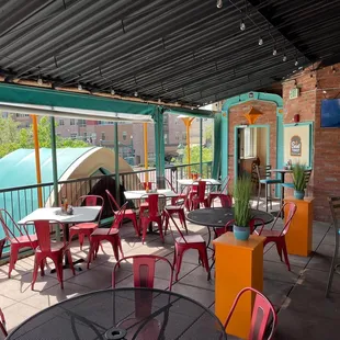 a patio with tables and chairs