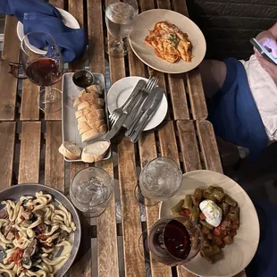 a wooden table with plates of food on it