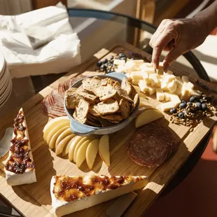 a platter of cheese, crackers, and meats