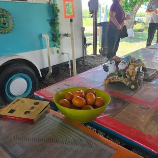 Outback eating area with literature and tangerines.