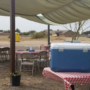 a picnic table with a cooler on it