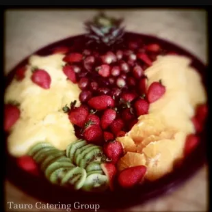 a plate of fruit and a pineapple