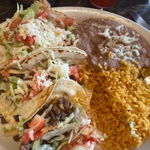 Steak tacos, grilled chicken taco with rice and beans.