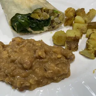 Egg &amp; cheese burrito with spinach and mushrooms added. Refried beans and home fries.