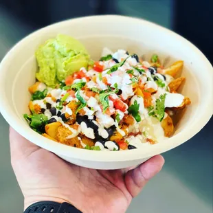 "Mexican fries" Crispy fries topped with shredded cheese, queso, black beans, meat of choice, guacamole, pico, sour cream and cilantro.