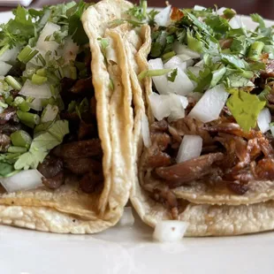 Left one is steak taco and right one is carnitas taco