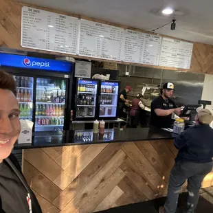 The employees and customer, at the order bar