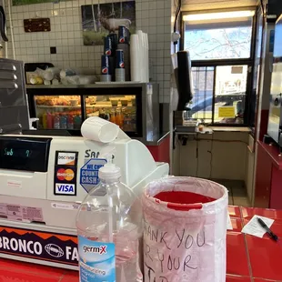 a bottle of water and a plastic bag on a counter