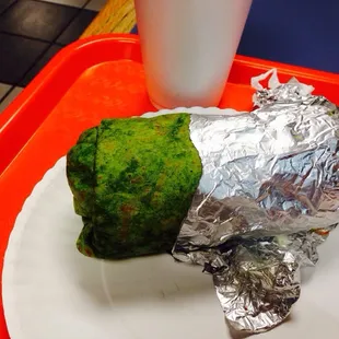 Al pastor burrito on spinach.