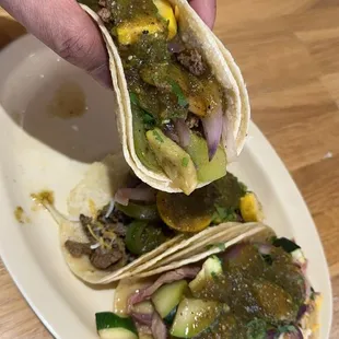 a hand holding a tortilla