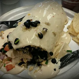 Chicken burrito smothered with queso.