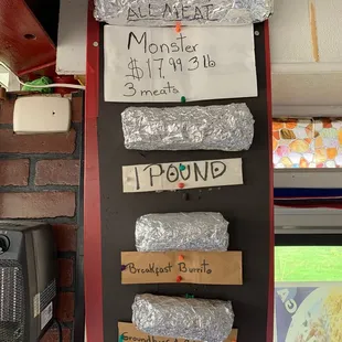 a display of burritos on a wall